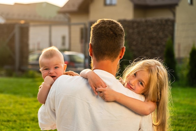 Father with happy and smiling children at summer