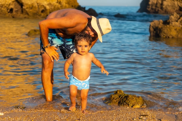 A father with his baby in the water at Praia dos Arrifes Algarve beach Albufeira Portugal