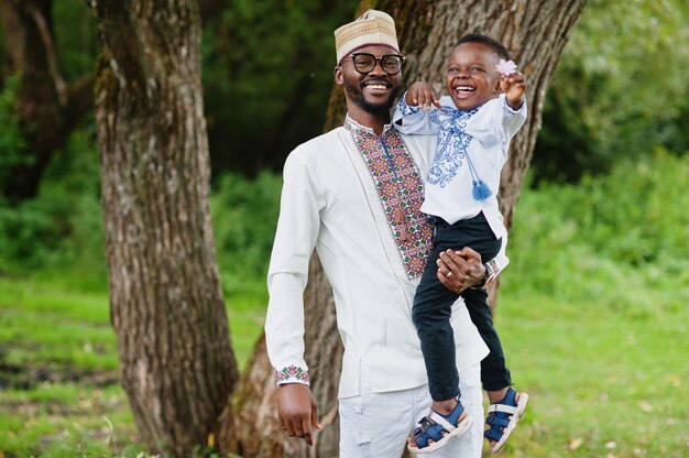 father with son in traditional clothes at park