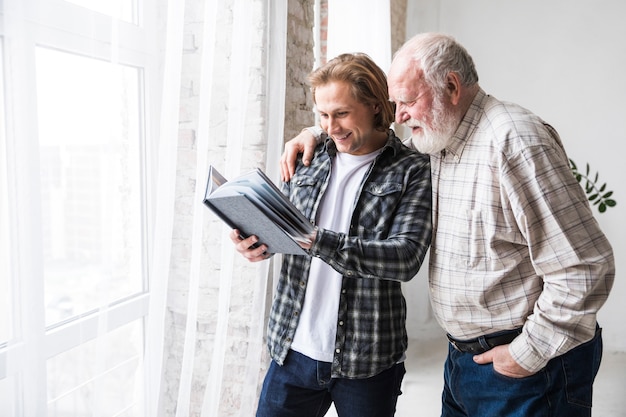 Photo father with son watching photo album