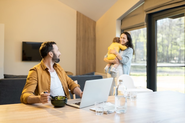 Father works from home with his family