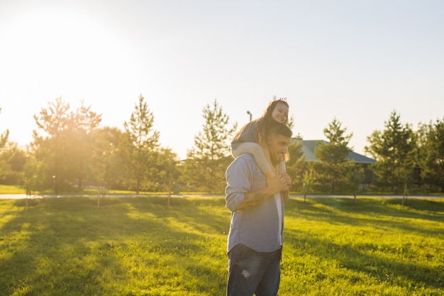 Fatherhood family and children concept  father and daughter having fun and playing in nature