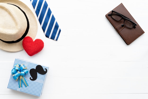 Fathers day accessories on bright white pastel wooden table background.