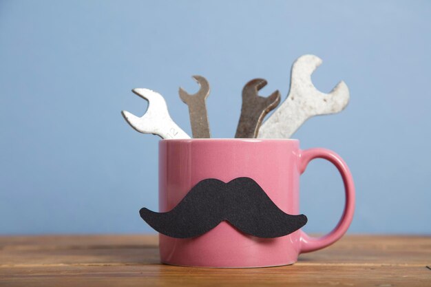 Fathers day background coffee mug with tools and a mustache