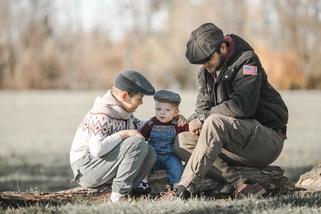 Photo fathers day brothers and their dad enjoying time together in naturecandid real family moment