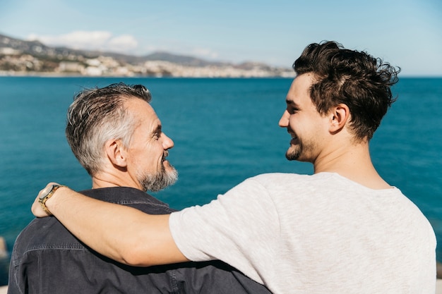 fathers day concept with father and son in front of sea