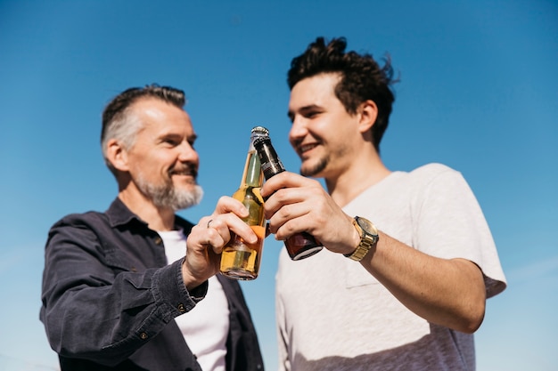 Fathers day concept with father and son toasting with beer