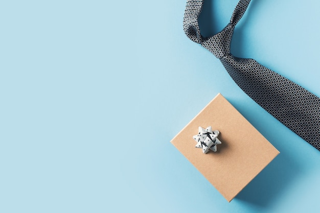 Fathers day concept with gift  box and tie on blue background