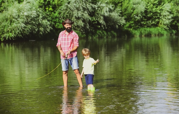 Fathers day dad and his child son are fishing on sky background fishing became a popular recreationa