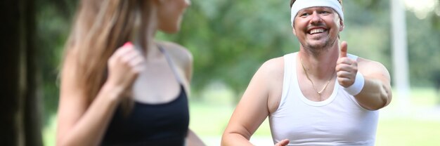 Fatty millennial man running in park with