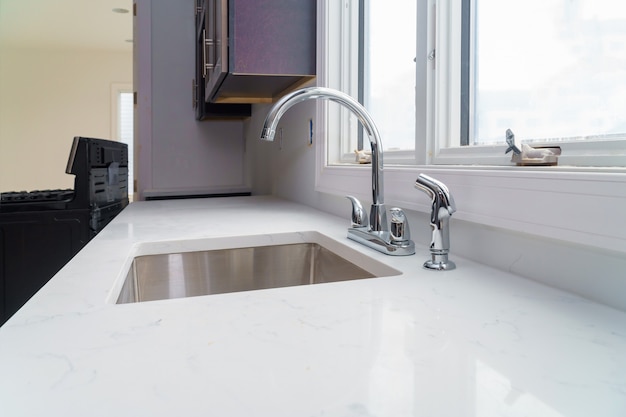 Faucet and kitchen sink with brick wall