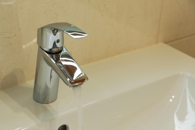 Faucet in modern bathroom space for text