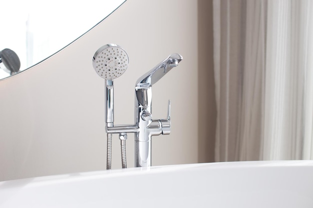 Faucet and shower in bathtub