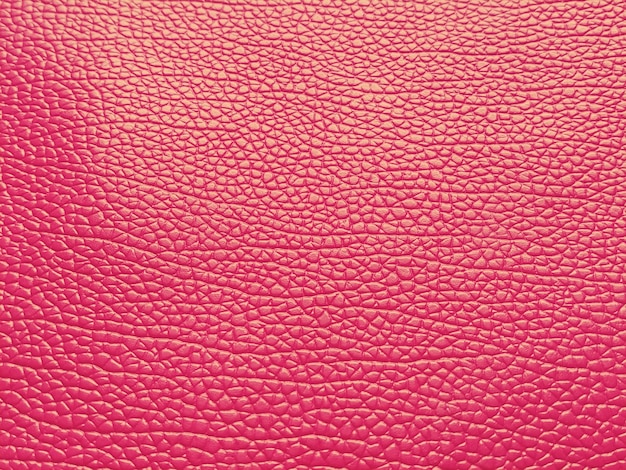 Faux leather scarlet separate grooves and elevations on the\
surface of a bag or shoe reflection of the light fashion accessory\
made of faux pig skin closeup