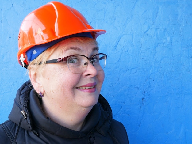 Feamle Engineer in the construction helmet, closeup