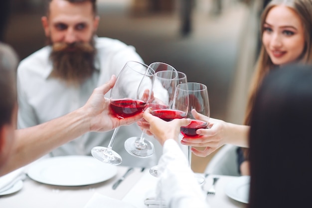 Feast. friends drink wine in a restaurant.