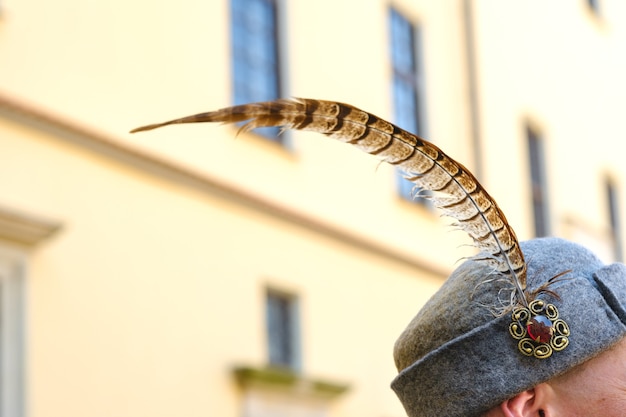 A feather in an old soldier's hat.Medieval concept.