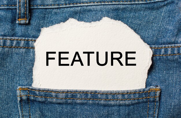 FEATURE on torn paper background on jeans business and finance concept