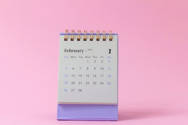 February 2023Desktop calendar on pink background for planning and management