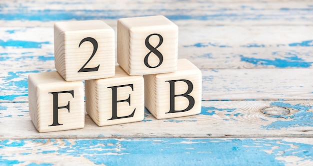 February 28th. Wooden cubes with date of 28 February on old blue wooden background.