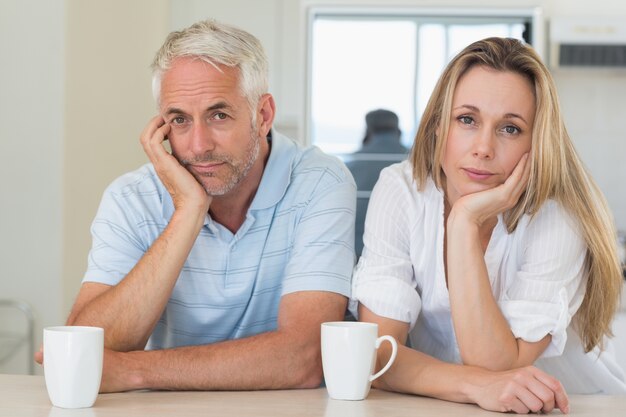 Fed up couple sitting at the counter 