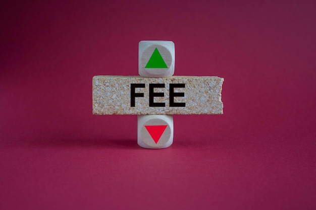 FEE symbol A wooden cubes with up arrow Brick block with the concept word FEE