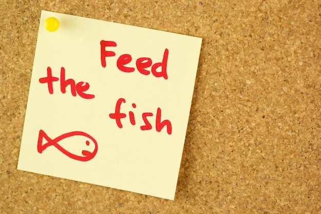 Feed the fish remind sticker on cork