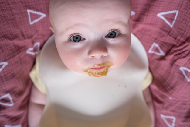 Feeding a little caucasian baby for first time