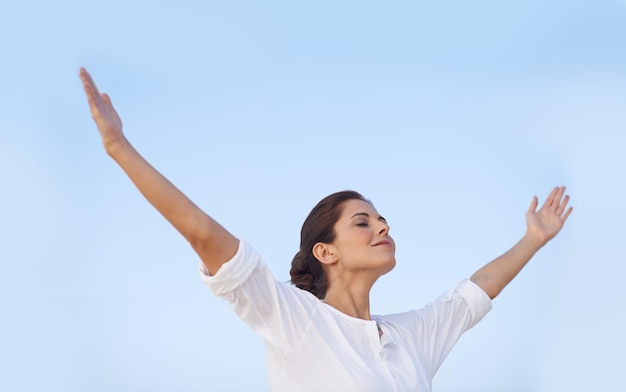 Feel the freedom A young woman standing with her arms outstretched