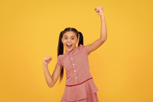 Feel like a winner Lucky winner yellow background Happy kid scream making winning gesture