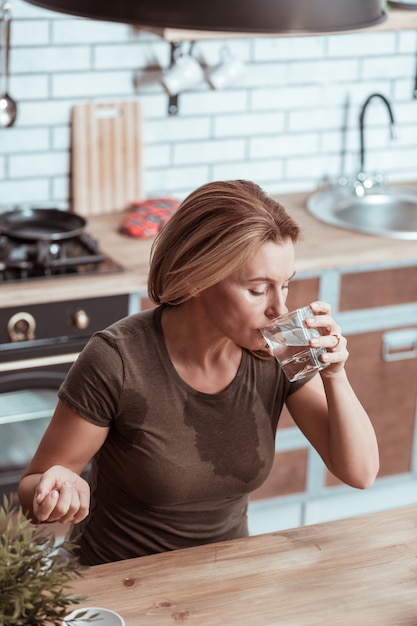 Photo feeling bad. sick woman feeling extremely sick and bad drinking water after taking pill