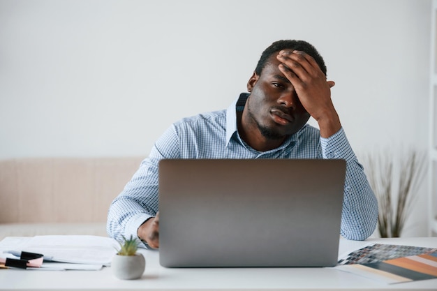 feeling bad stressful businessman is working in the office by laptop