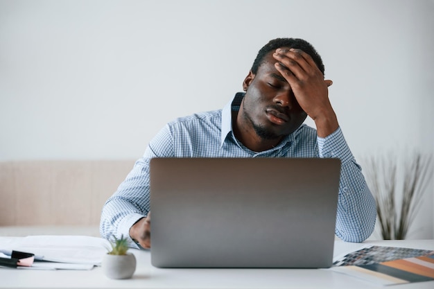 feeling bad stressful businessman is working in the office by laptop