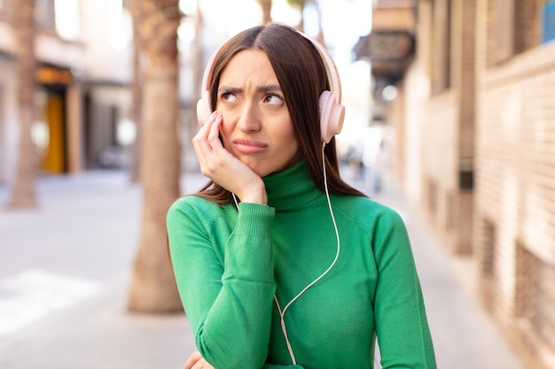 Foto sentirsi annoiato, frustrato e assonnato dopo un faticoso ascolto di musica con le cuffie