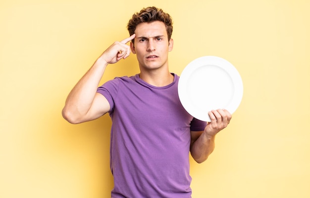 Feeling confused and puzzled, showing you are insane, crazy or out of your mind. empty plate concept