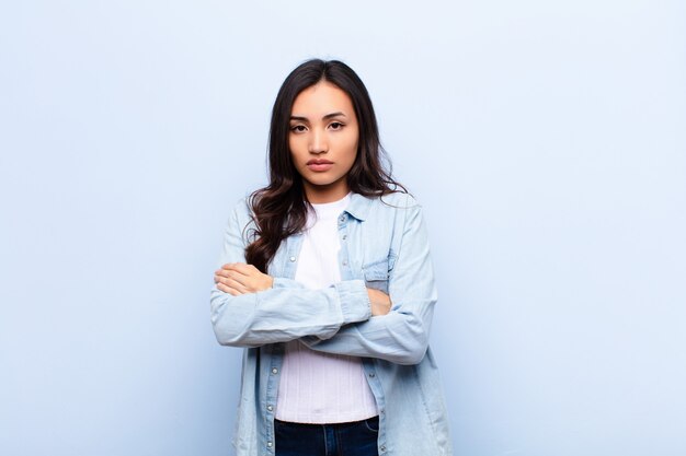 feeling displeased and disappointed, looking serious, annoyed and angry with crossed arms