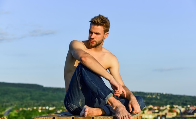 Feeling free and confident shirtless guy relax at sunrise young athletic guy with muscular body sportsman and fitness model naked strong man muscular strong man has bristle on face