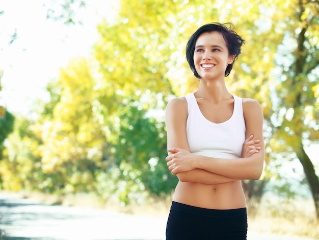 Feeling great about her health and fitness A fit young woman standing outdoors with her arms crossed