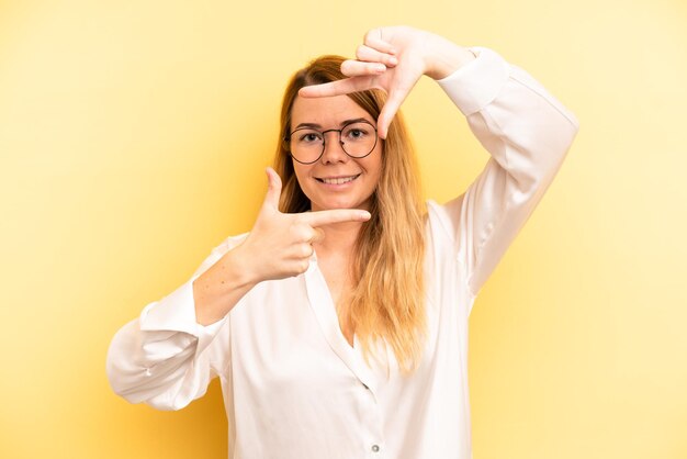 Feeling happy friendly and positive smiling and making a portrait or photo frame with hands