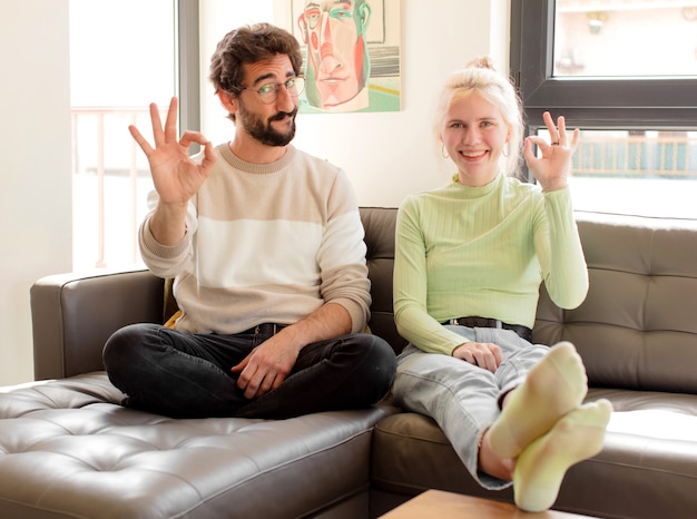 Feeling happy, relaxed and satisfied, showing approval with okay gesture, smiling