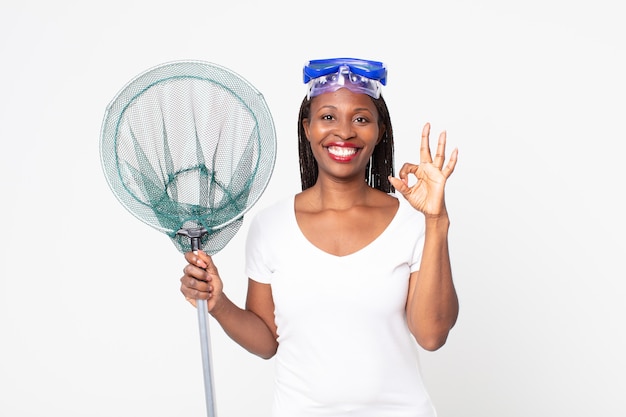 feeling happy, showing approval with okay gesture with goggles and fisher net