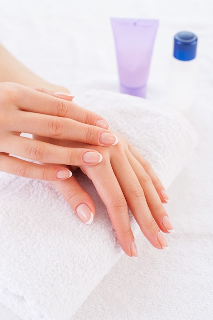 Feeling her skin smooth. Close-up of beautiful female hands on the towel