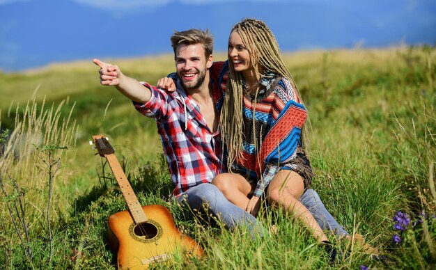 Feeling of love happy friends with guitar couple in love spend free time together friendship campfire songs men play guitar for girl western camping hiking country music romantic date