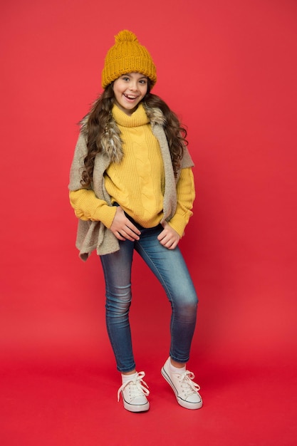 Feeling playful. happy childhood. cold season look for teen girl. knitted clothing style. take care of health. cheerful child wear warm winter clothes. seasonal kid fashion. stay cozy and comfortable.