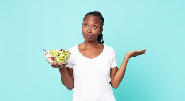 Feeling puzzled and confused and doubting and holding a salad