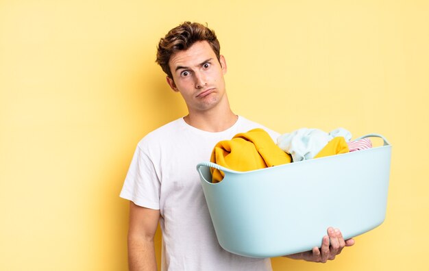 Feeling puzzled and confused, with a dumb, stunned expression looking at something unexpected. washing clothes concept