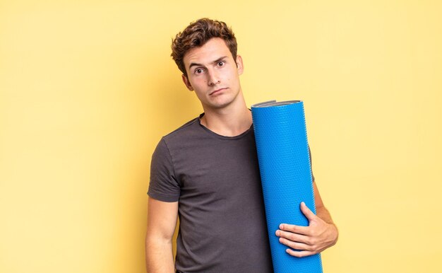 Feeling puzzled and confused, with a dumb, stunned expression looking at something unexpected. yoga mat concept