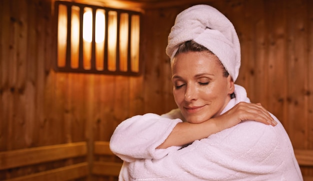 Feeling serene in the sauna Shot of a mature woman in a sauna