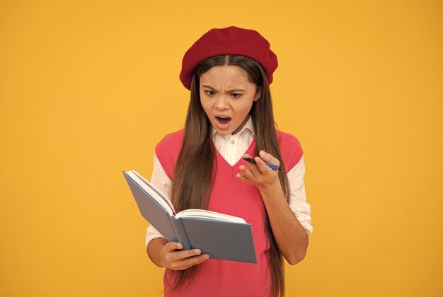 Feeling shock shocked french teen girl hold notebook childhood happiness