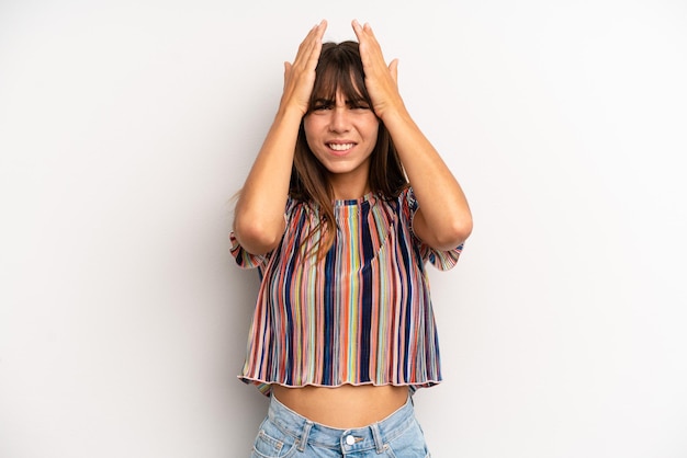 feeling stressed and anxious depressed and frustrated with a headache raising both hands to head